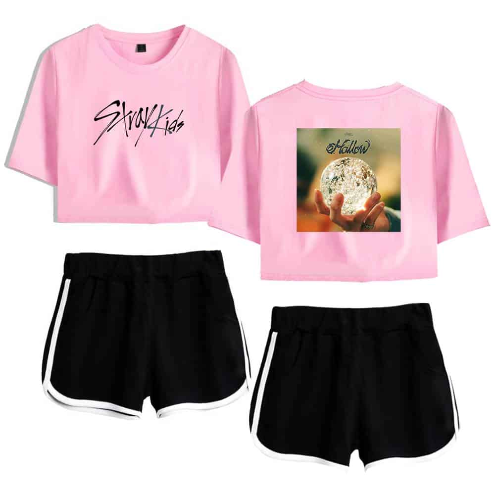Teenage korean pop girl group merchandise with pastel pink crop tops and black shorts.