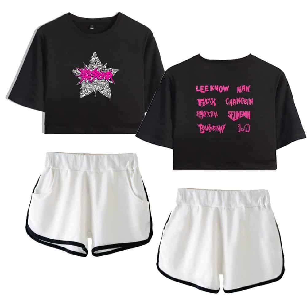 Black graphic crop top with K-pop band design and pink text on the back, paired with white shorts with black trim. Perfect for K-pop fans and merch collectors.